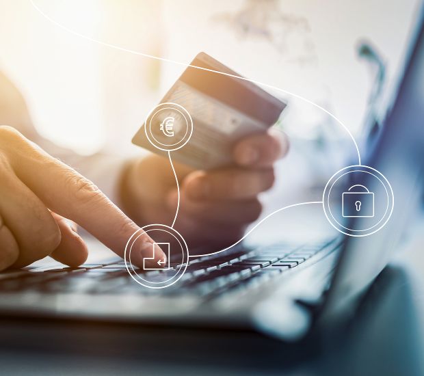 Cyber Safety, @BRZ person entering numbers on a keypad with a credit card in hand